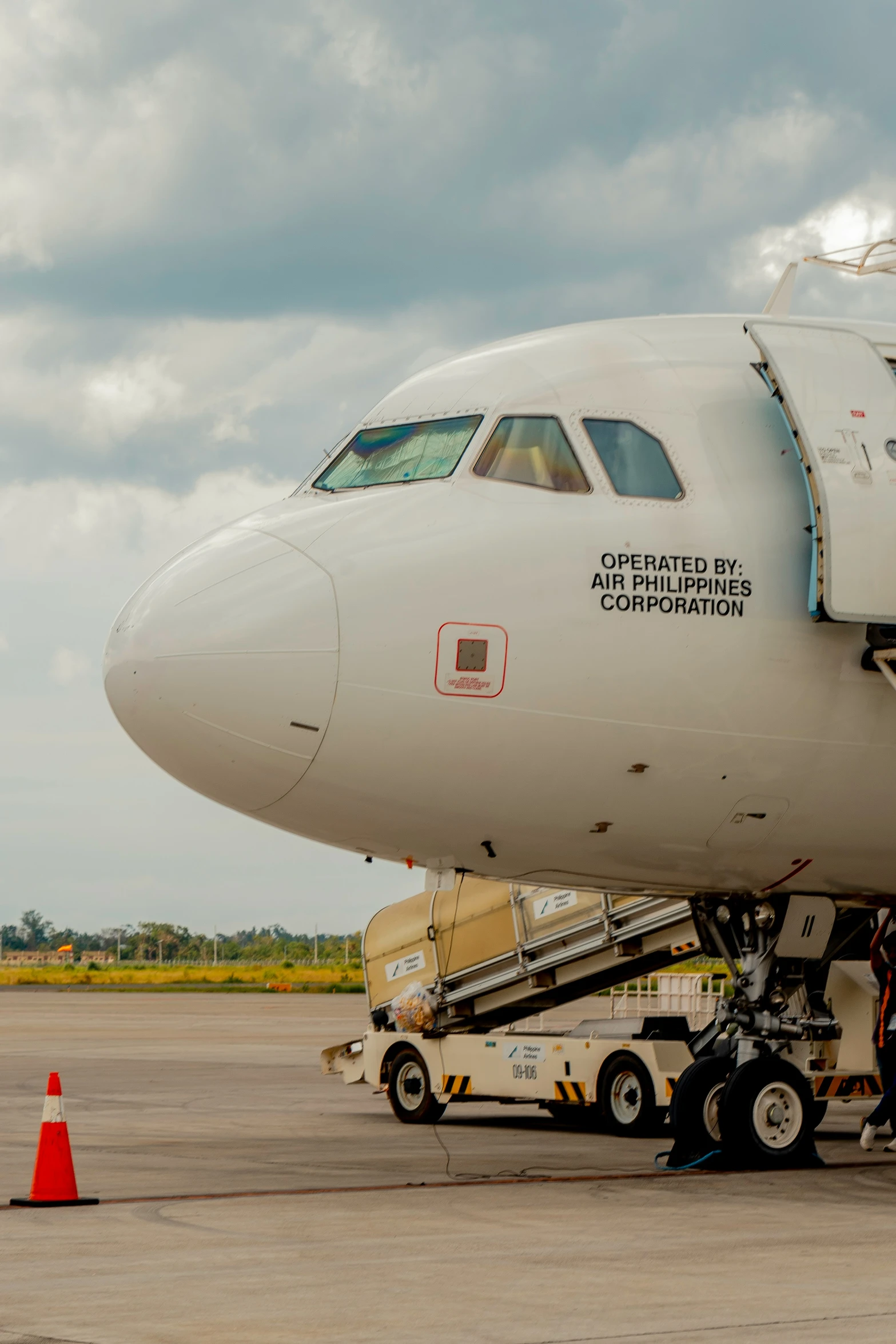 large commercial jet with stairs at gate to open area