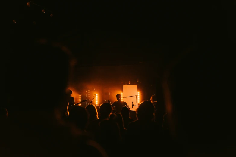 a group of people standing around in the dark