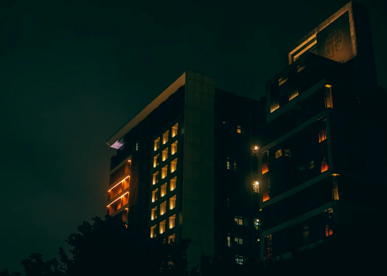 a tall building illuminated up in the dark at night