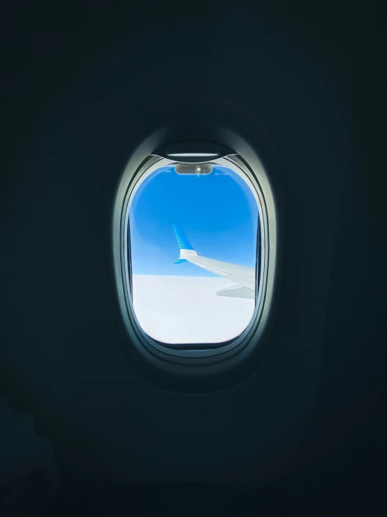 a view out an airplane window with snow