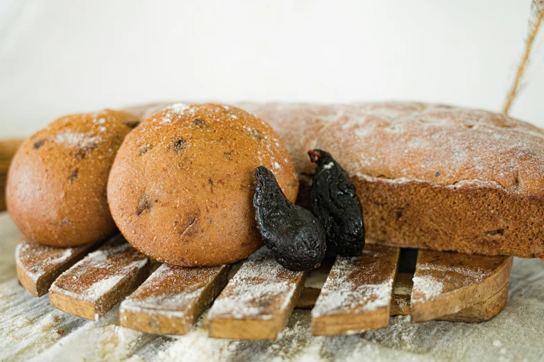 a close up of several pieces of bread on a wooden  board