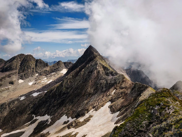 a large mountain range covered in snow and cloud