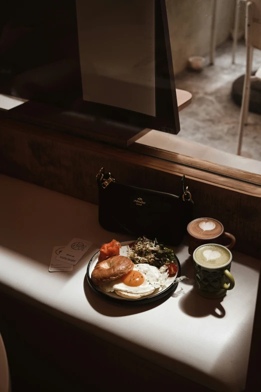 a table with a plate of food and a cup on it