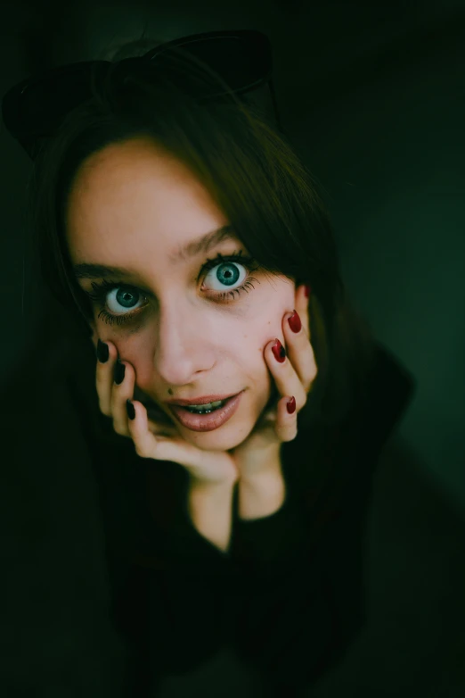 a woman with long brown hair and blue eyes poses for the camera