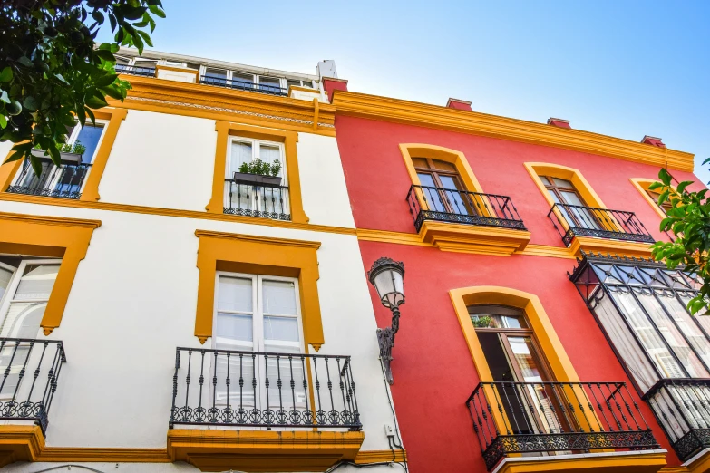 there are multiple colored buildings with balconies