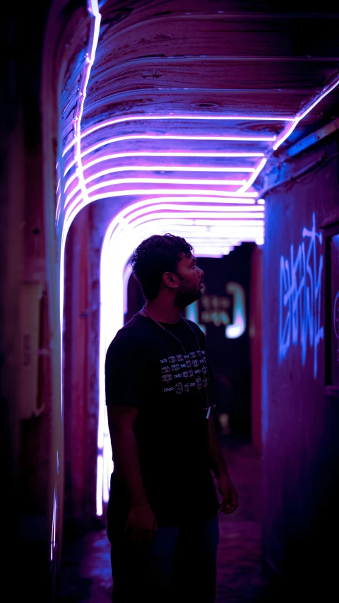 man walking under an underground tunnel in the middle of the night