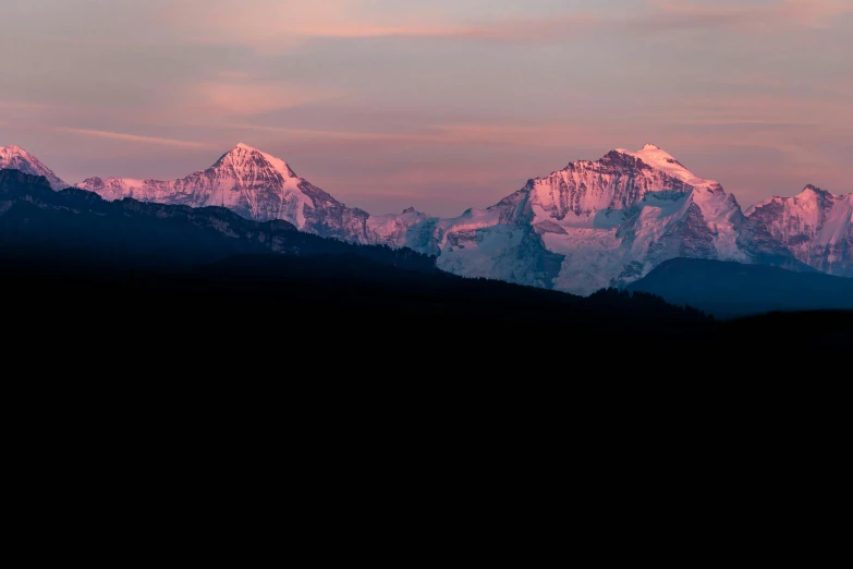 mountains and clouds with some pinkish purple light