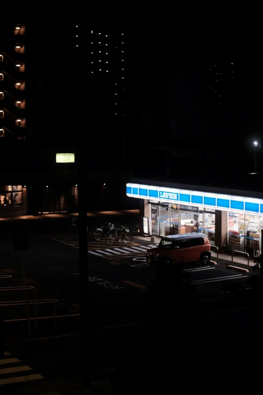 a lit up gas station at night with the lights on