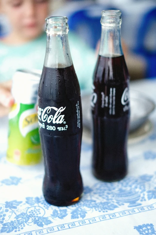 bottles of soda sitting on top of a table