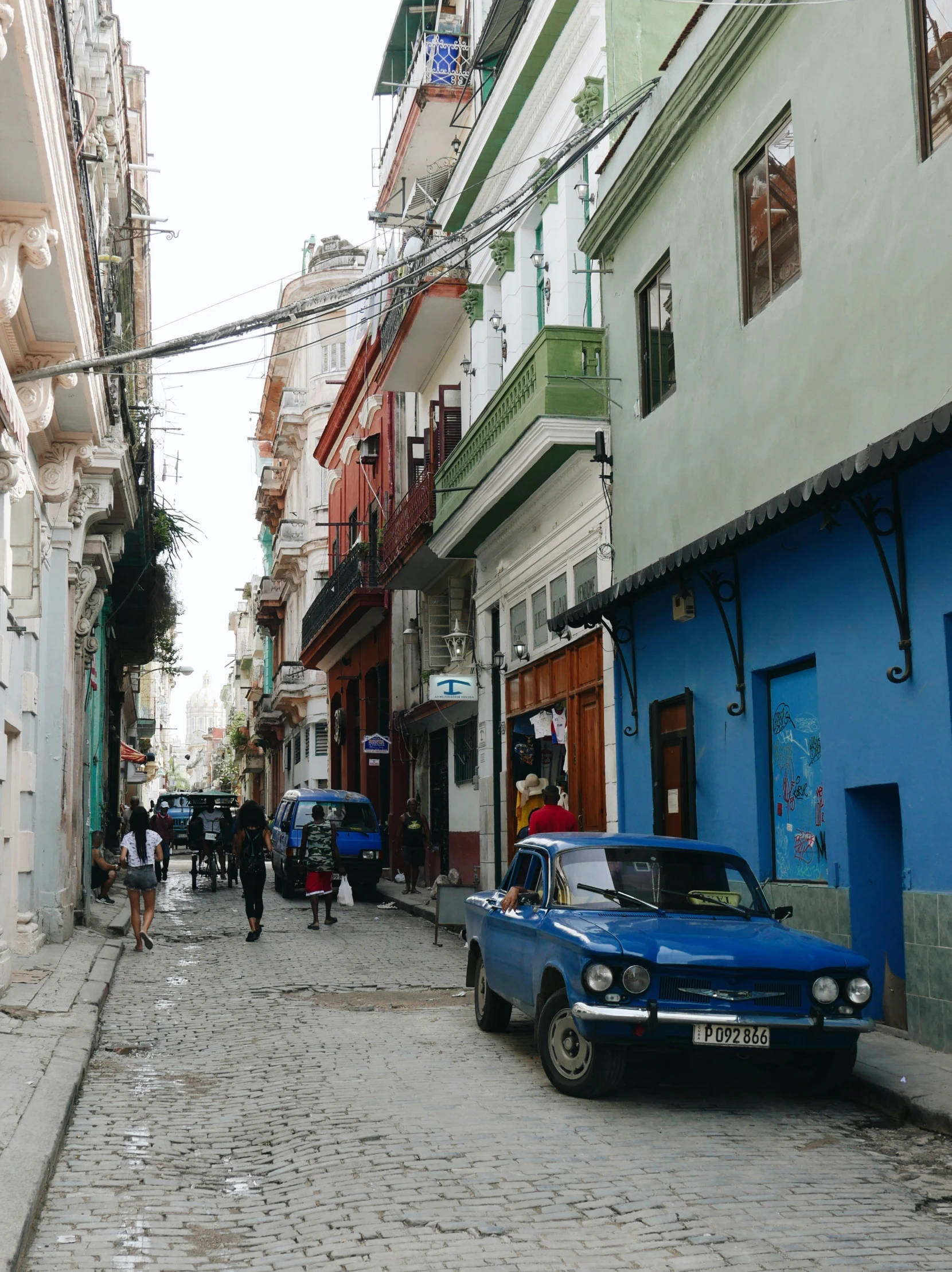 a street with some people walking on the sidewalks