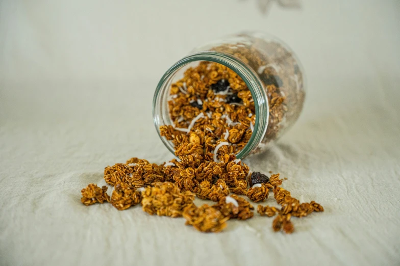 a small jar filled with granola sitting on top of a table