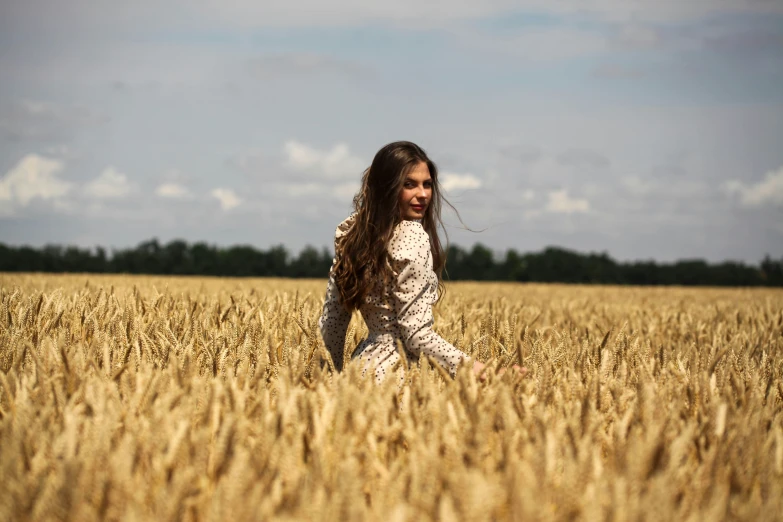 a  is running in a large wheat field