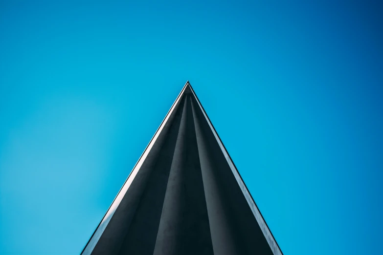 a tall black object against a blue sky