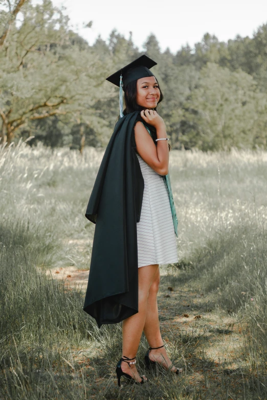 a woman in a graduation gown and hat