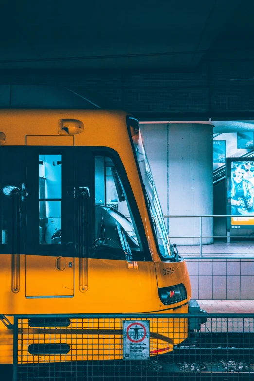 there is a yellow bus parked in the station