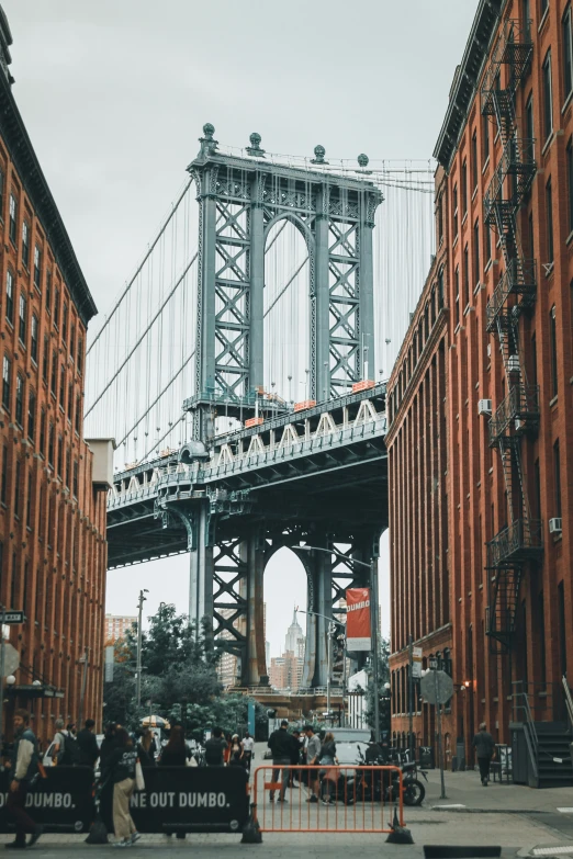 an old vehicle passes underneath the bridge on a city street