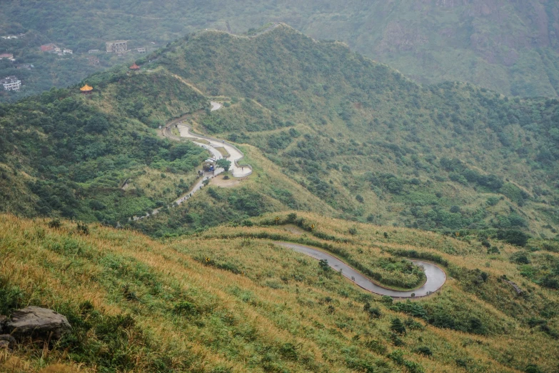 a winding road winding a narrow hillside