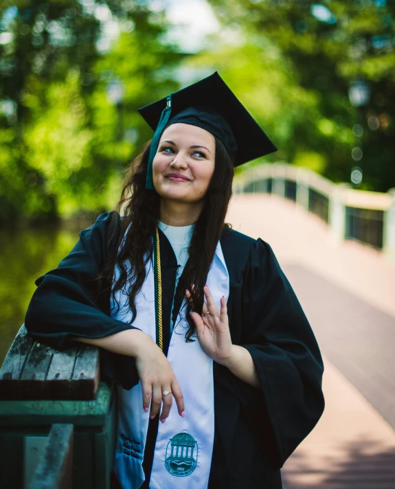 a woman is standing at her graduation day