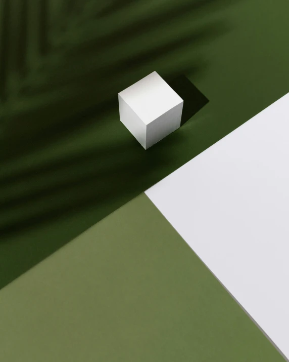there is a white cube sitting next to an open rectangular box