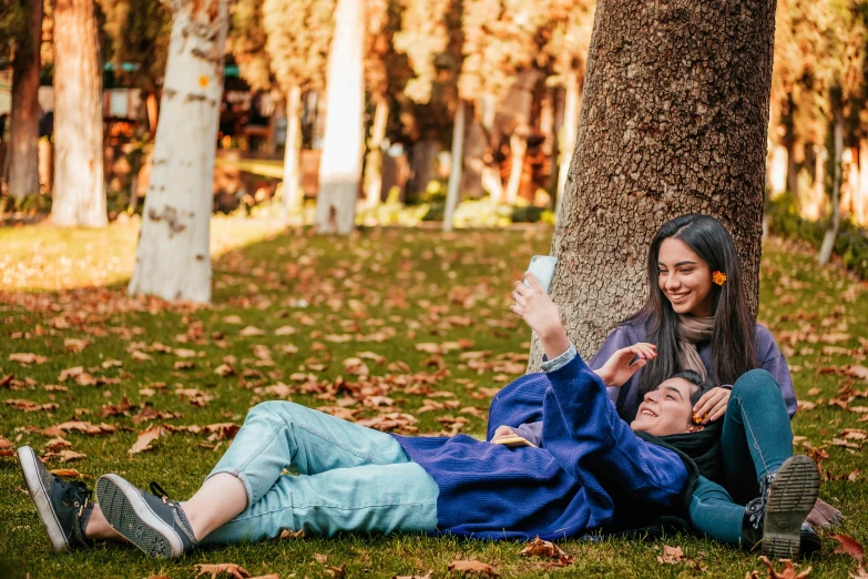 the two people are resting on the ground