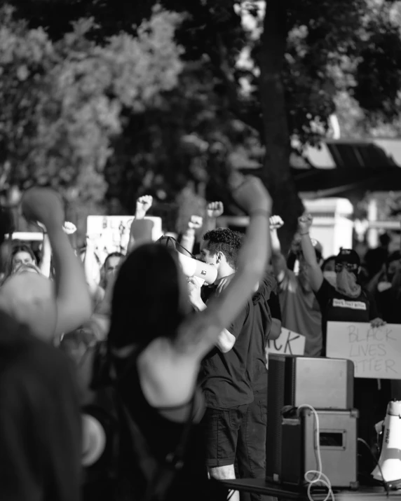 a crowd of people standing around each other