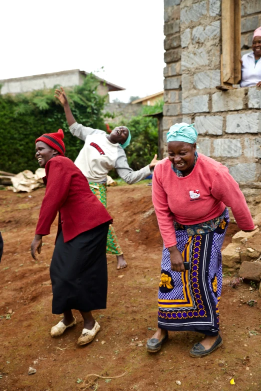 several women outside of an old brick building