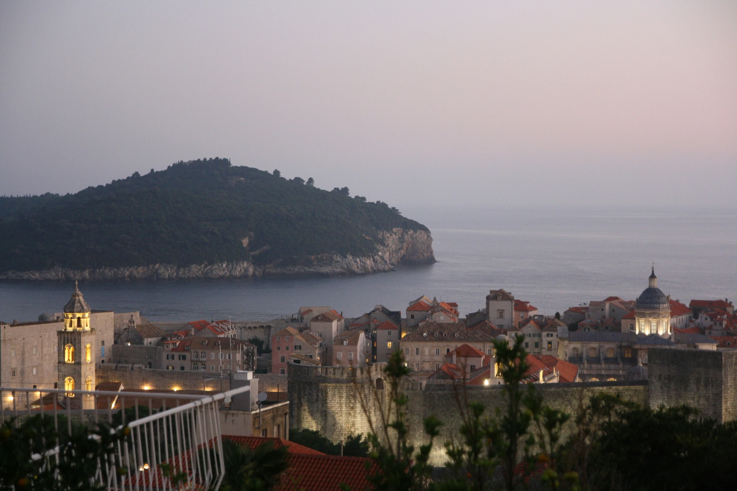 a city and the sea from above at twilight