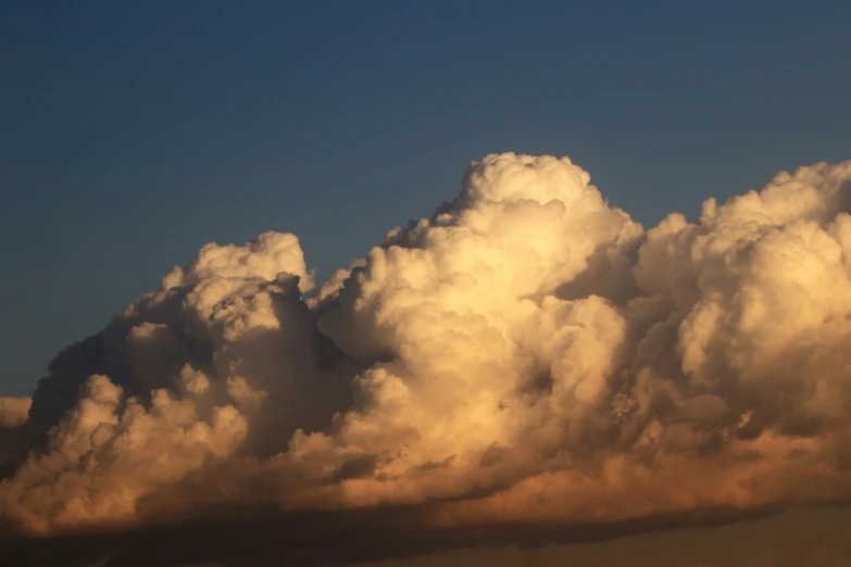 clouds over a field on a sunny day