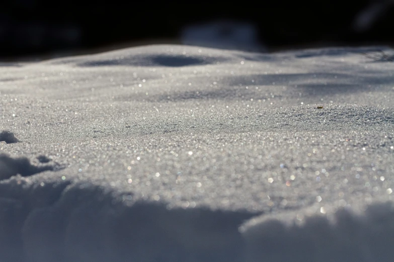 snow is falling off the top of a mound