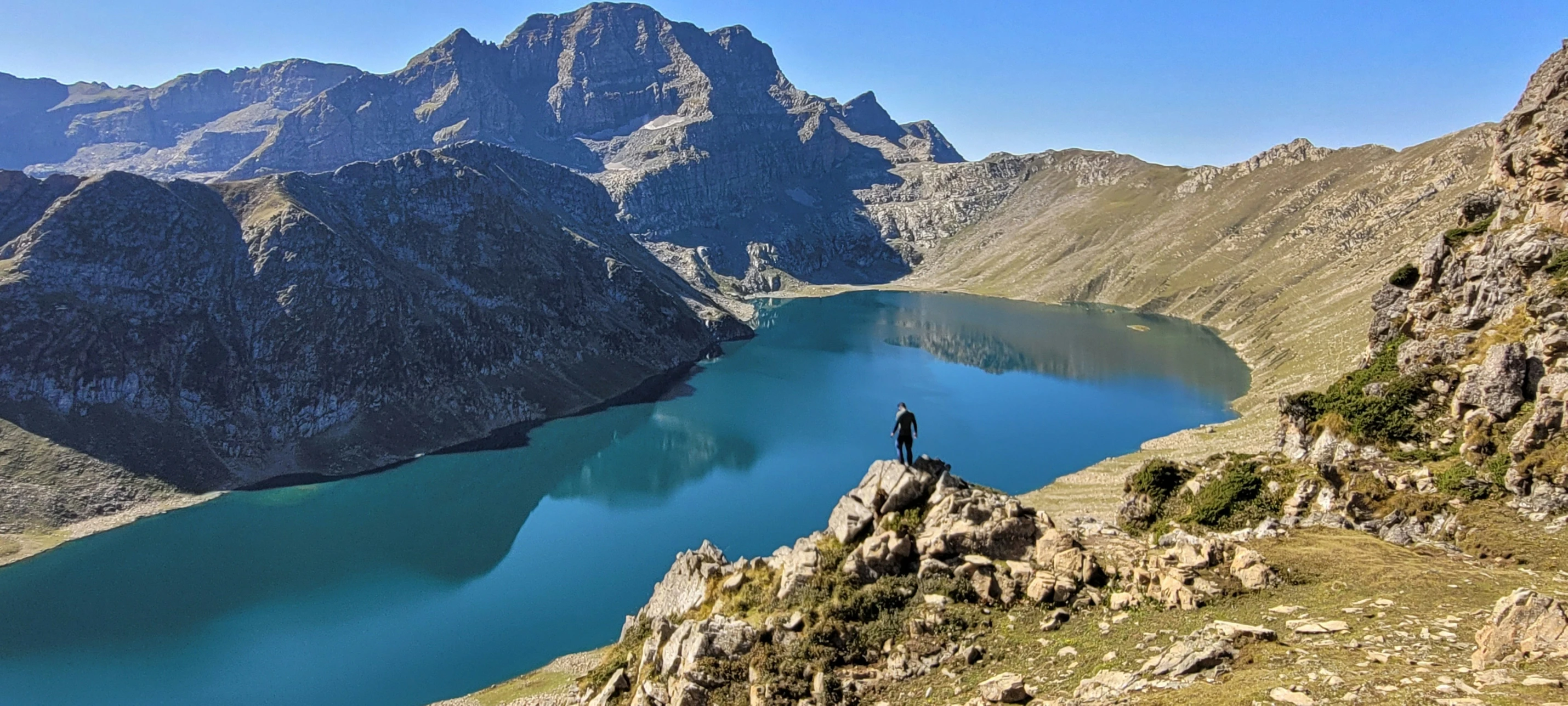 the person is standing on the side of a mountain