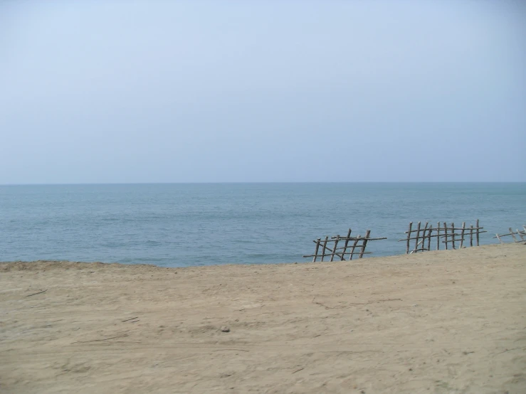 a couple of chairs in the sand on the beach