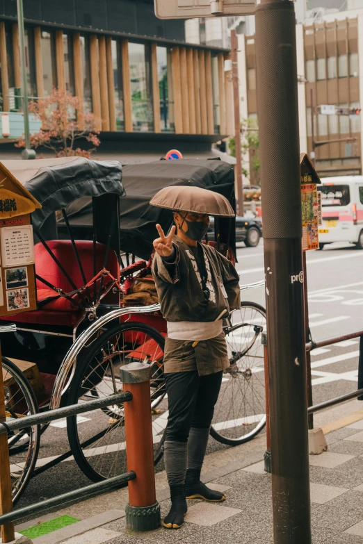 a man standing on the sidewalk using his cellphone