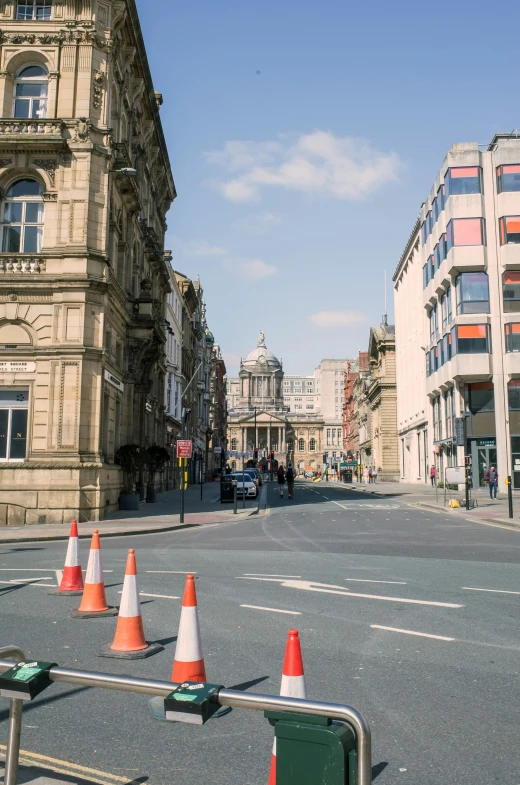 an orange cone sits on the corner of the street