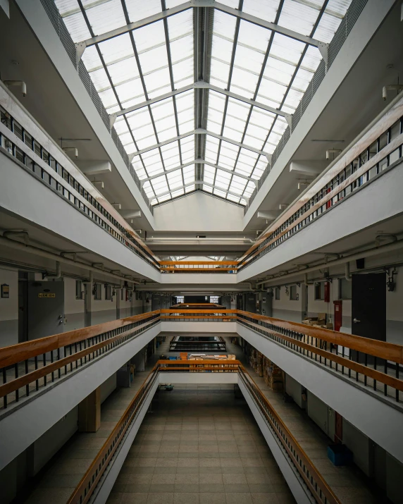 the interior of a building with lots of wood and glass