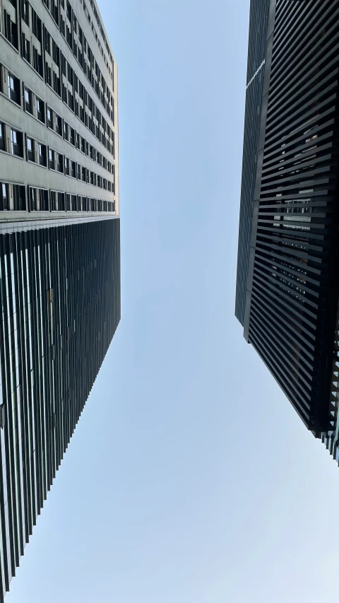 view up at several tall black building from the ground