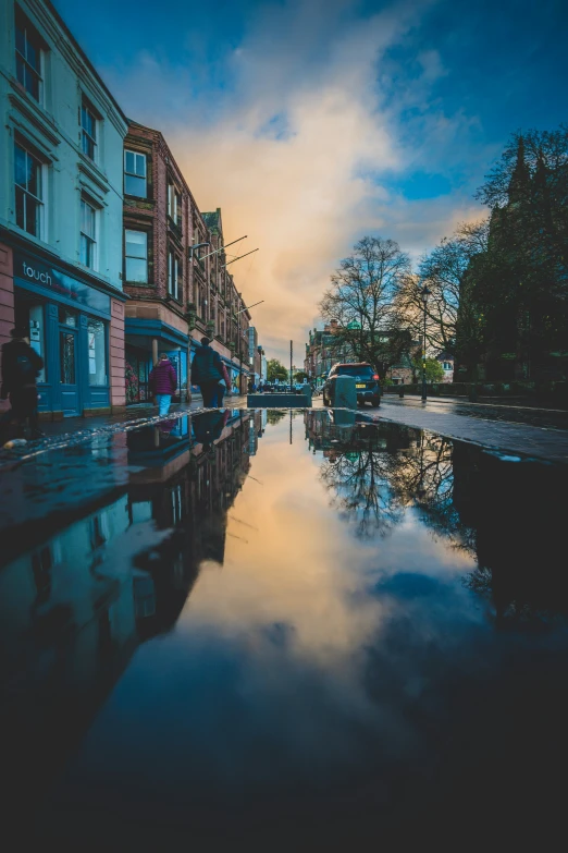 street scene showing water on the pavement and buildings