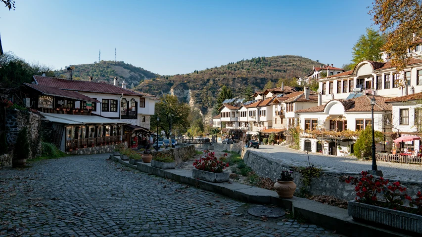 people sitting outside a bar with beautiful mountain scenery