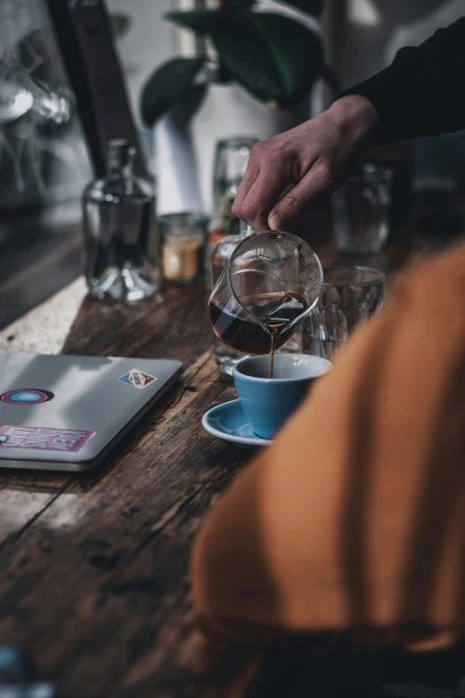 an image of coffee being poured into a cup