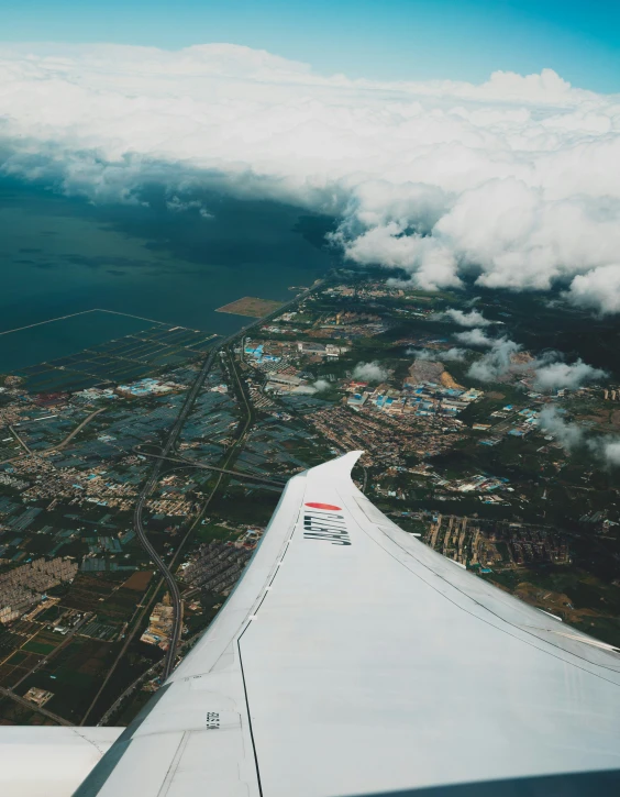 an airplane wing with clouds and the view from above