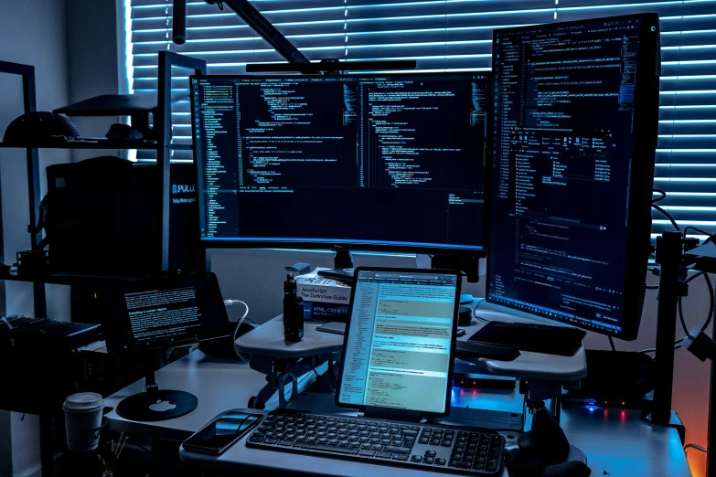 a computer monitor sitting in front of two monitors