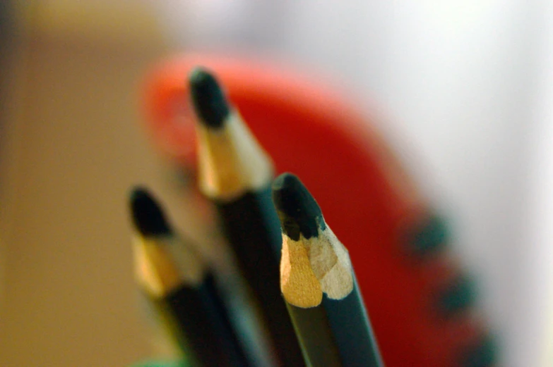 a few pencils that are sitting in a cup