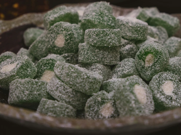 green and white dessert treats are in a bowl