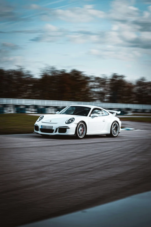 an automobile with the wheel turned sideways on a race track