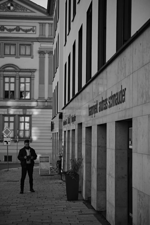 a person that is standing in front of some buildings