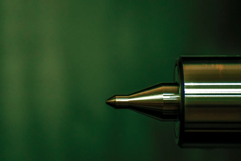 a metallic door handle with a green background