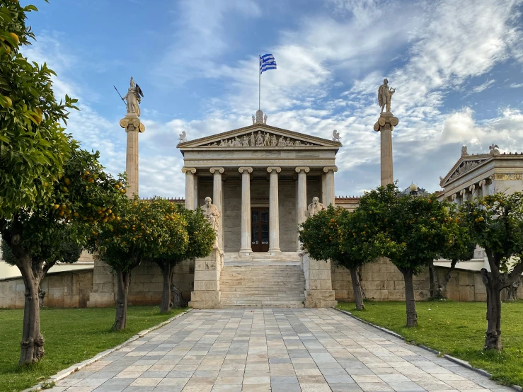 a building with columns and steps and trees