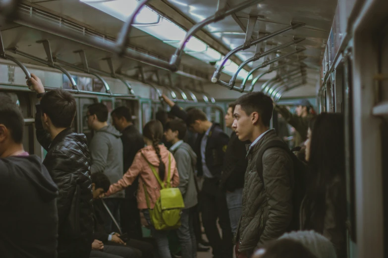 a crowded subway train car with people inside