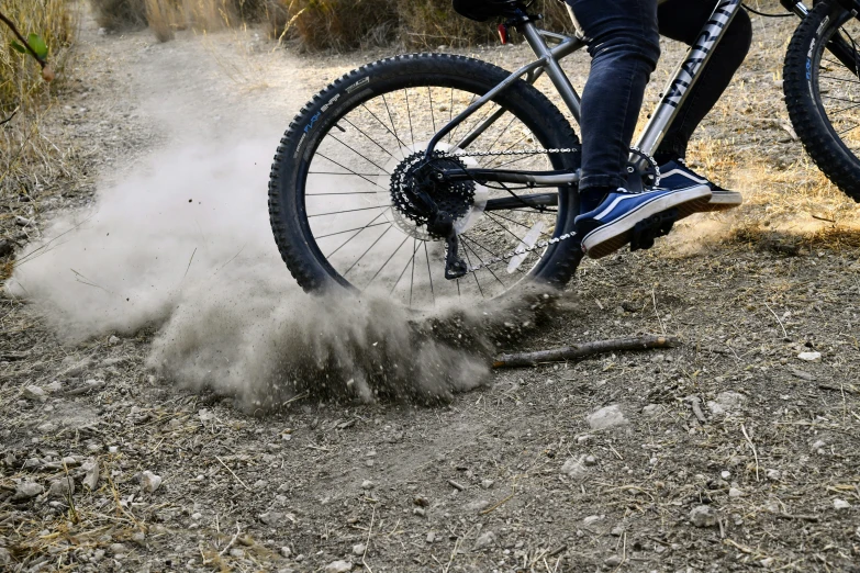 mountain bike rider riding through the dust and sand