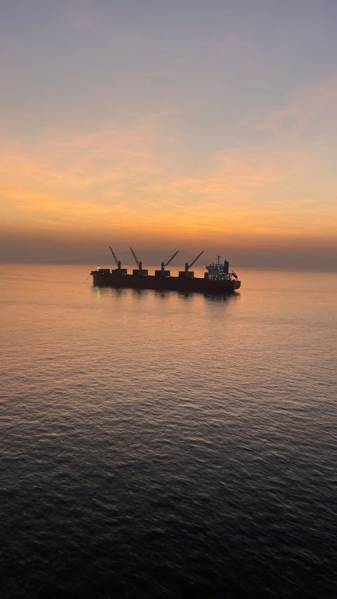 a large boat sitting out in the middle of the ocean