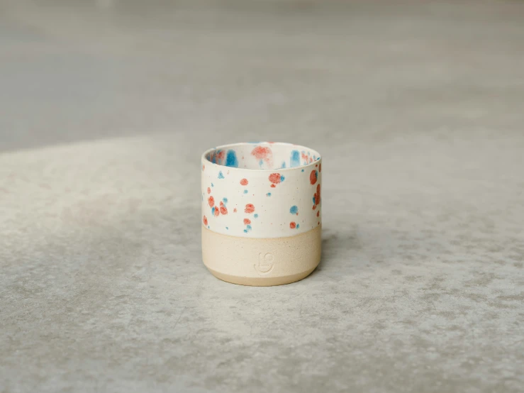 a small vase sitting on top of a cement floor